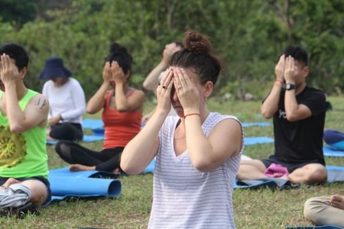People practising yoga meditation outdoors